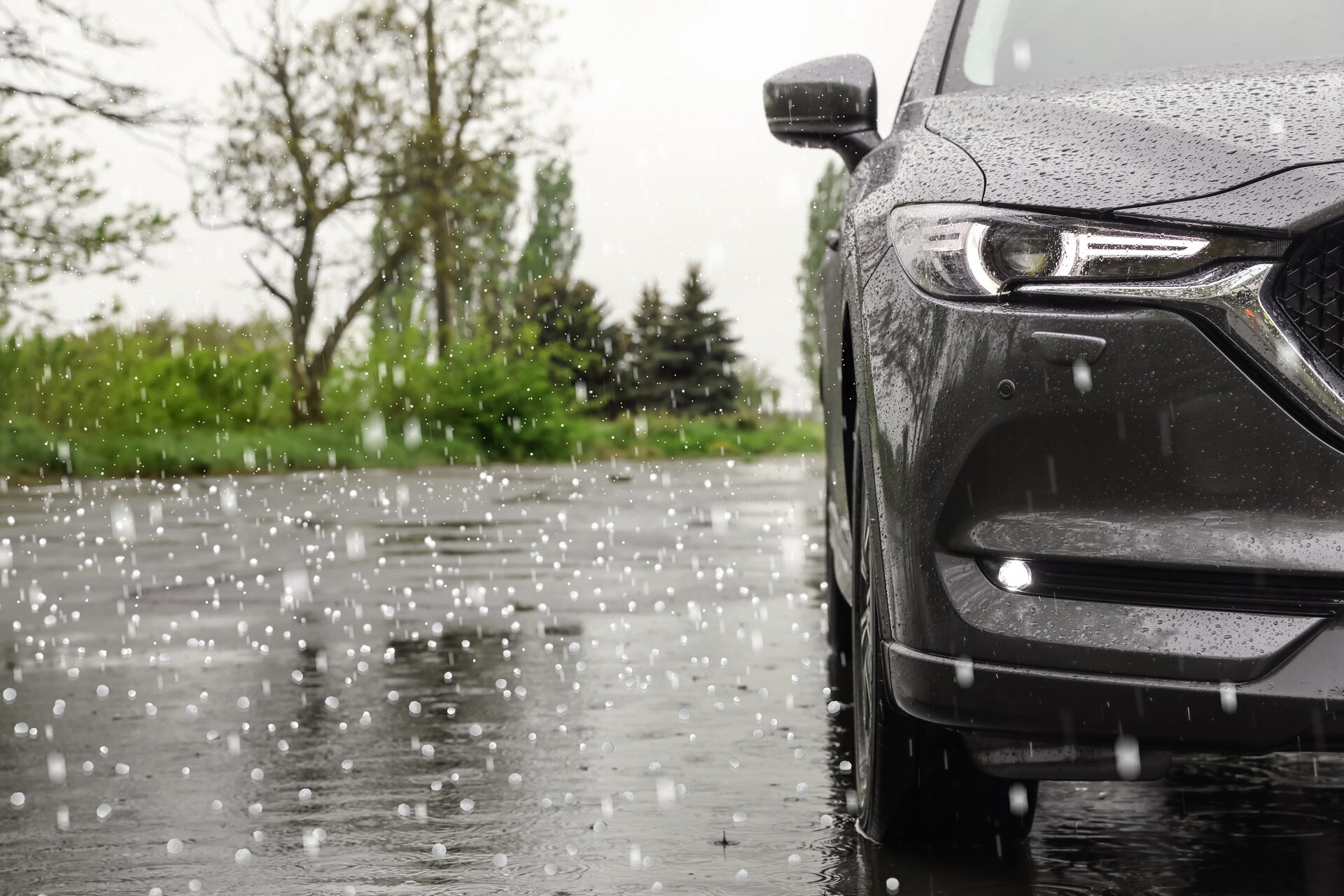 Car hood with severe hail dents — Denver PDR hail damage repair